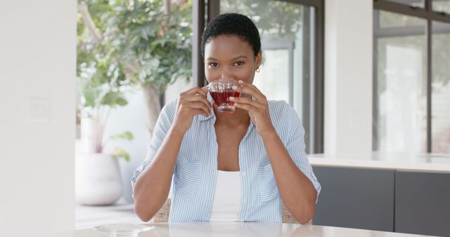 Woman Enjoying Herbal Tea in Bright Modern Kitchen - Download Free Stock Images Pikwizard.com