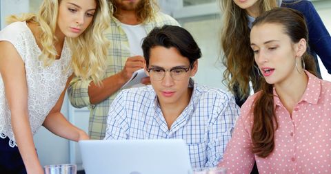 Diverse Team Collaborating on Project at Work