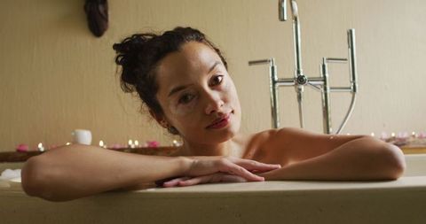 Serene woman relaxing in bathtub during self-care routine