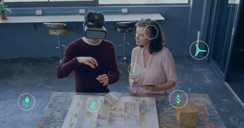 Architects reviewing 3d model with virtual reality headset and tablet in creative studio