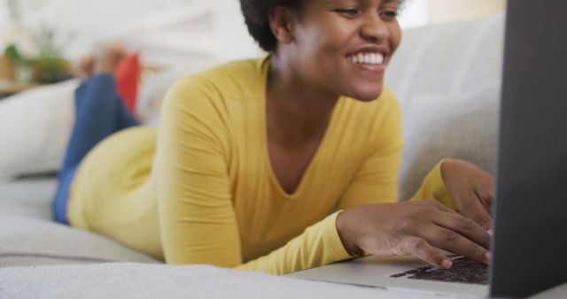 Smiling Woman in Yellow Shirt Using Laptop at Home - Download Free Stock Images Pikwizard.com