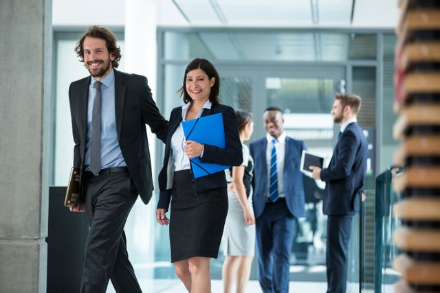 Businesswoman walking with colleagues in office