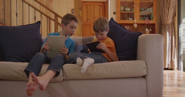 Two Boys Enjoying Digital Tablets at Home - Download Free Stock Images Pikwizard.com