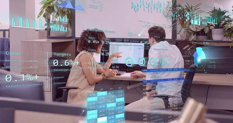 Business Professionals Analyzing Financial Charts with Holographic Data