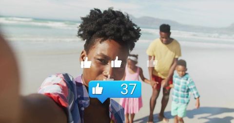 Taking beach selfie with family while social media likes bubble showing 37 notifications