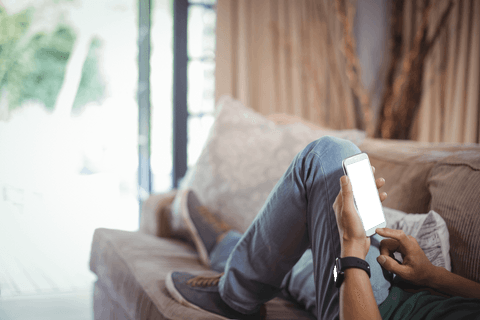 Transparent Smartphone Interaction by Relaxed Individual on Cozy Sofa - Download Free Stock Videos Pikwizard.com