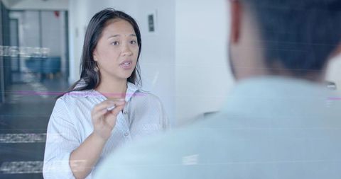 Professional discussion in modern corporate hallway