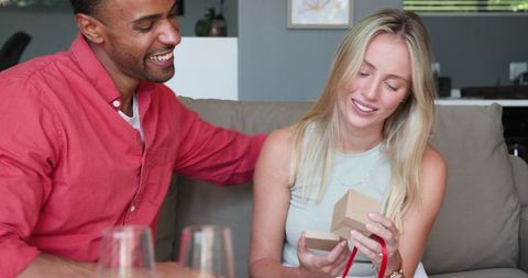 Couple Celebrating Gift Exchange at Home Gathering