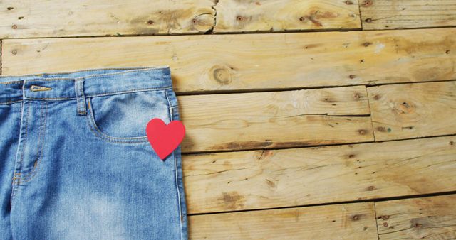 Close up of jeans with red heart on wooden background with copy space - Download Free Stock Photos Pikwizard.com
