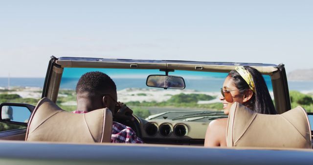 Portrait of african american couple sitting in the convertible car on road. road trip travel and adventure concept