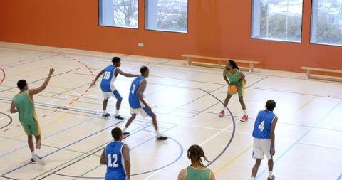 Youth basketball game action competitively played