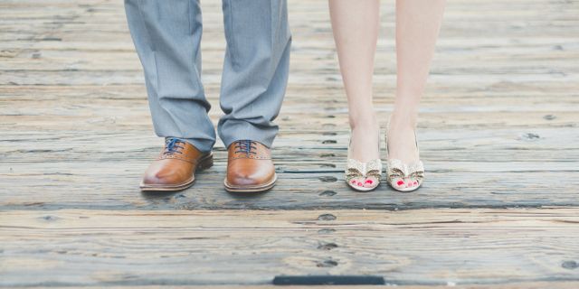 Close-up of Couple's Feet on Wooden Deck - Download Free Stock Photos Pikwizard.com