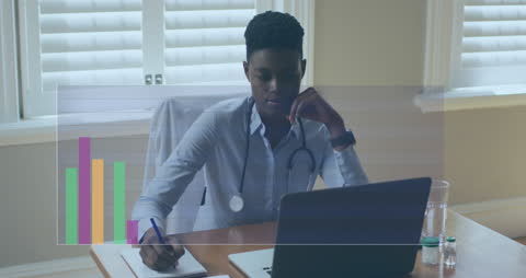 African American Doctor Processing Data on Laptop