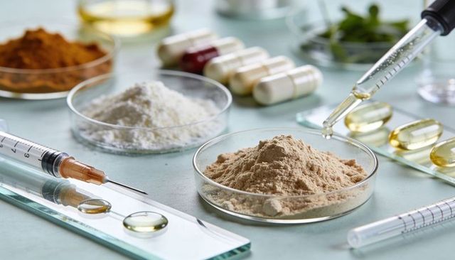 Formulating natural supplement powders and oils in laboratory with capsules and pipette
