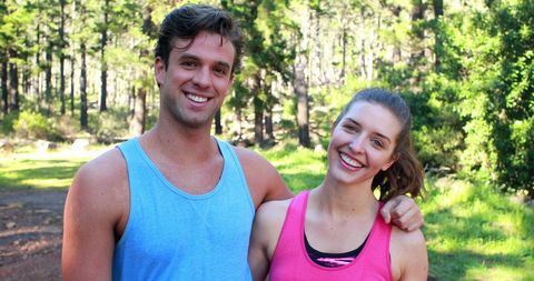 Smiling Couple Enjoying Outdoor Workout in Natural Setting