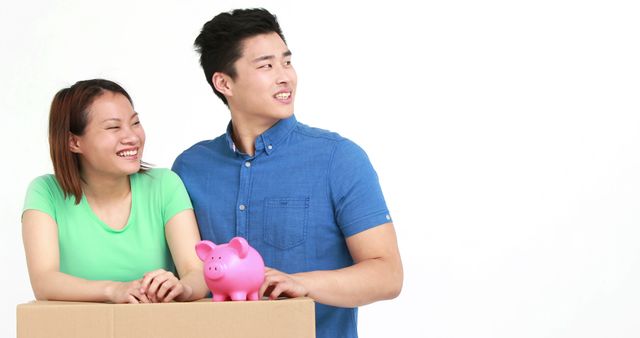 Happy Young Couple Moving into New Home with Piggy Bank - Download Free Stock Images Pikwizard.com