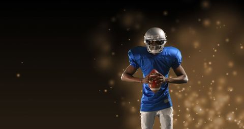 American football player holding ball with bokeh background