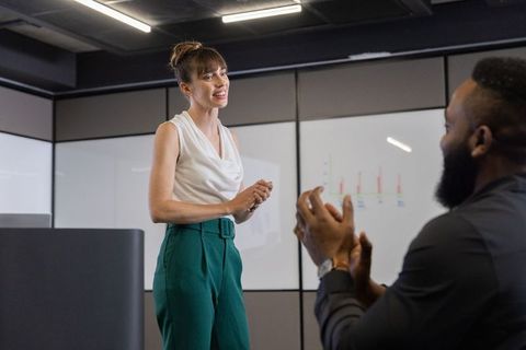Businesswoman presenting in modern office meeting room