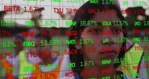 Asian woman monitoring operations with stock market data