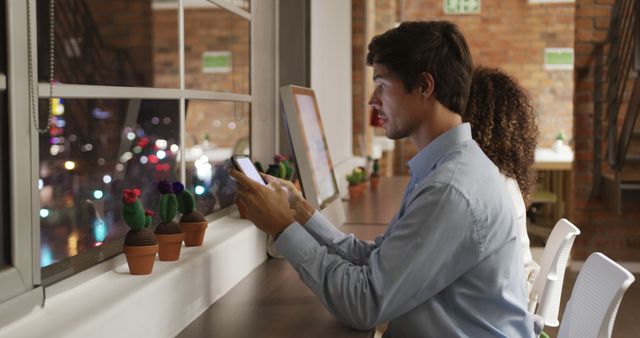 Man Using Smartphone in Cozy Office at Night - Download Free Stock Images Pikwizard.com