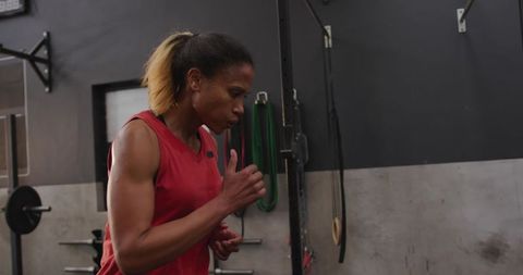 Determined athlete running drill in gym environment