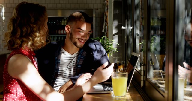 Smiling Couple Sharing Moments Together in Sunlit Café - Download Free Stock Images Pikwizard.com