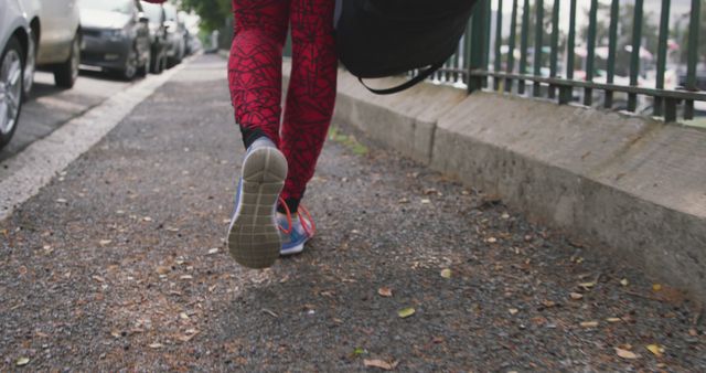 Close-up of Person Jogging on Urban Sidewalk with Athletic Wear - Download Free Stock Images Pikwizard.com