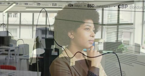 Professional Woman Analyzing Financial Charts in Modern Office