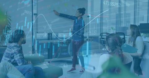 Diverse team analyzing financial charts in modern office setting
