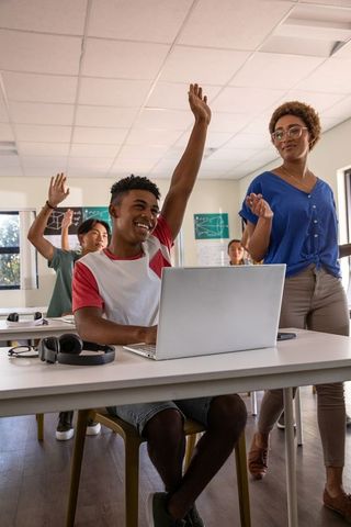Interactive learning with engaged students and teacher in modern classroom