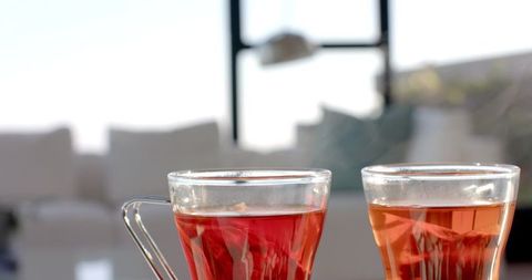 Cozy Home with Red Herbal Tea in Glass Mugs by Sunlit Window