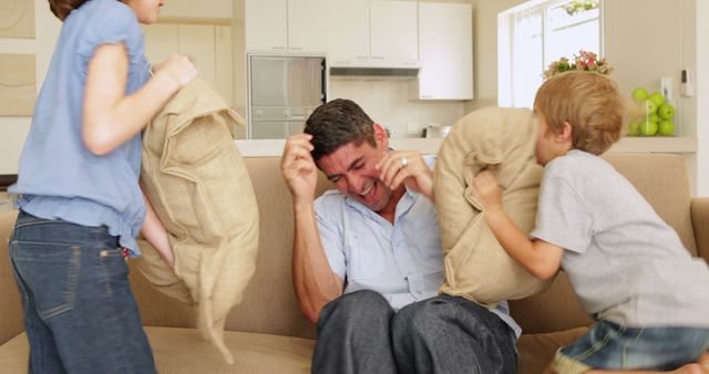 Father Enjoying Pillow Fight with Children in Living Room - Download Free Stock Images Pikwizard.com