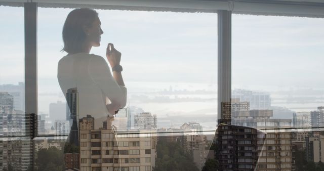 Businesswoman Contemplating City skyline from High-rise Window - Download Free Stock Images Pikwizard.com