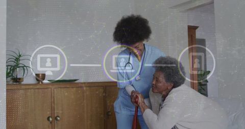 Caregiver helping senior woman with cane at home using telehealth and mobility support