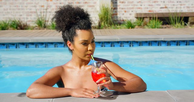 Young Woman Relaxing in Pool Drinking Refreshing Cocktail - Download Free Stock Images Pikwizard.com