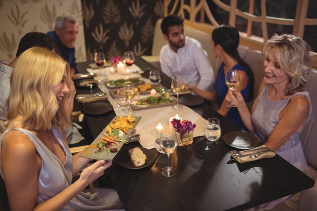 Friends Enjoying Dinner at Elegant Restaurant - Download Free Stock Photos Pikwizard.com