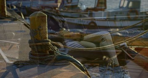 Reflective woman checking phone on sunny marina dock