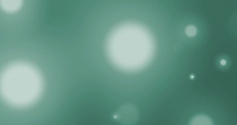 Hypnotic glowing light spots on green background