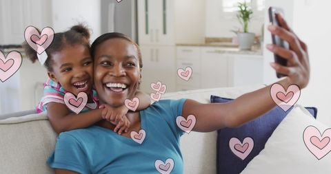 Mother and Daughter Taking Selfie Surrounded by Hearts