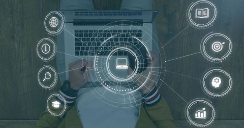 Overhead man typing on laptop holding mug with hud productivity interface and icons