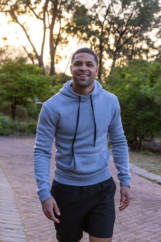 African American Man Strolling in Park at Twilight in Casual Wear