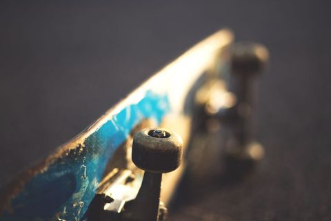 Urban Skateboard Deck with Worn Blue Paint in Focus