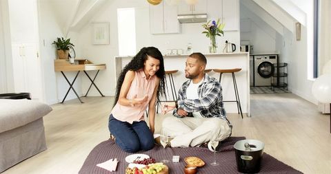 Happy Couple Celebrating with Picnic Indoors