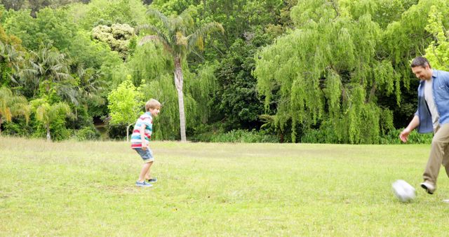 Father and Son Playing Soccer in Green Park - Download Free Stock Images Pikwizard.com