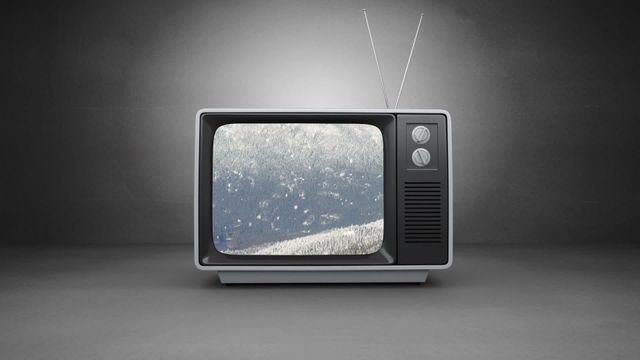 Retro TV with snowy screen against dark background portraying nostalgia and vintage media. Perfect for projects related to television history, analog technology, or nostalgic themes.