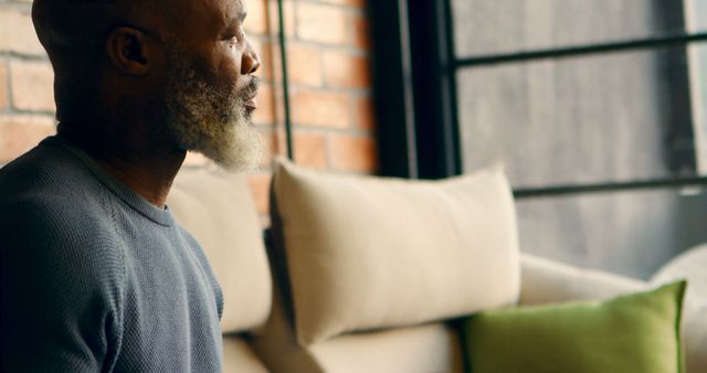 Pensive Elderly African American Man Sitting by the Window - Download Free Stock Images Pikwizard.com