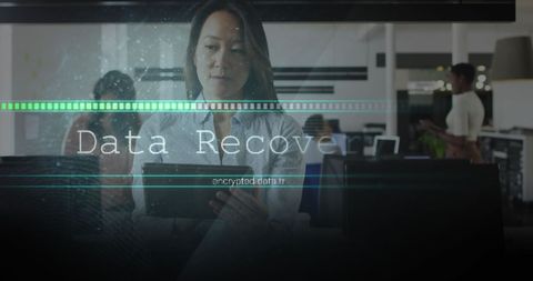 Asian Businesswoman Engaged in Data Recovery in Modern Office