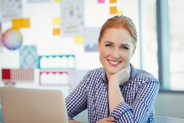 Portrait of smiling female executive sitting in office
