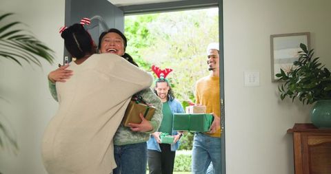 Friends rejoicing with gift exchange at festive gathering
