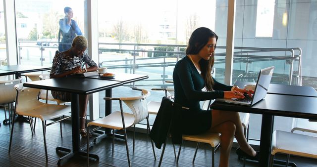 People Working and Relaxing in Modern Cafe with Large Windows - Download Free Stock Images Pikwizard.com